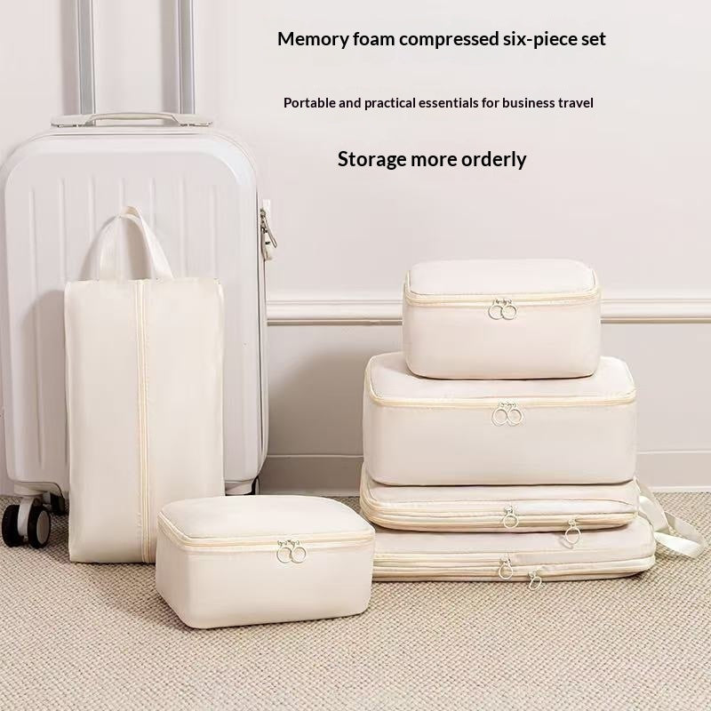 Complete packing cube set stacked beside a carry-on suitcase