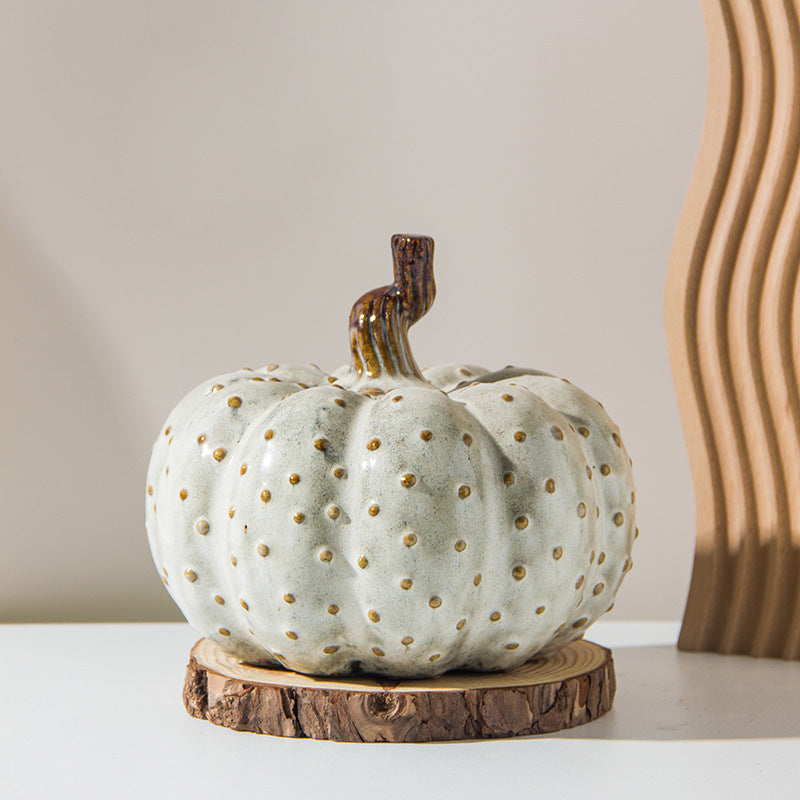 White Ceramic Pumpkin — on a wood slice with decor