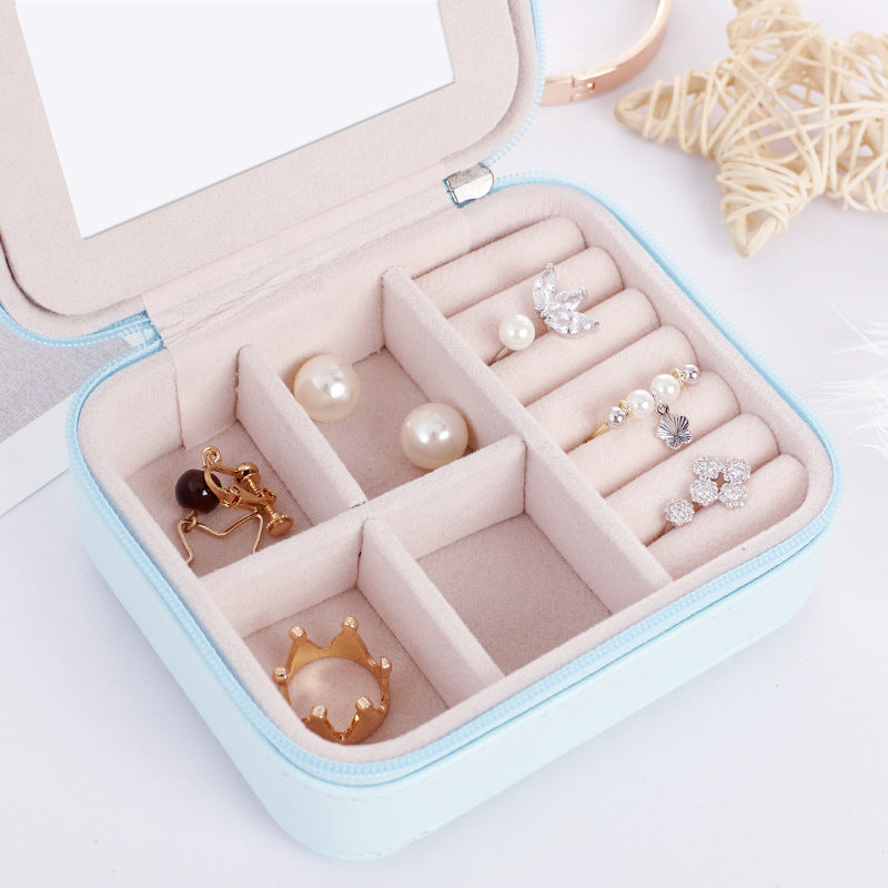 Jewelry case with pearl necklace and earrings in velvet trays