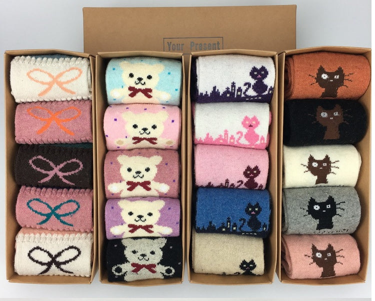 Display of cozy sock gift boxes showing the range of knit patterns