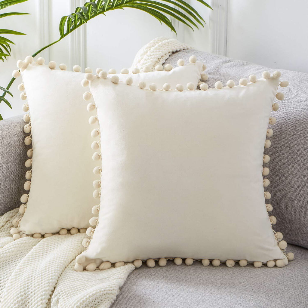 Pom Pom Velvet Pillow Cover — pillow on an armchair with pom pom trim