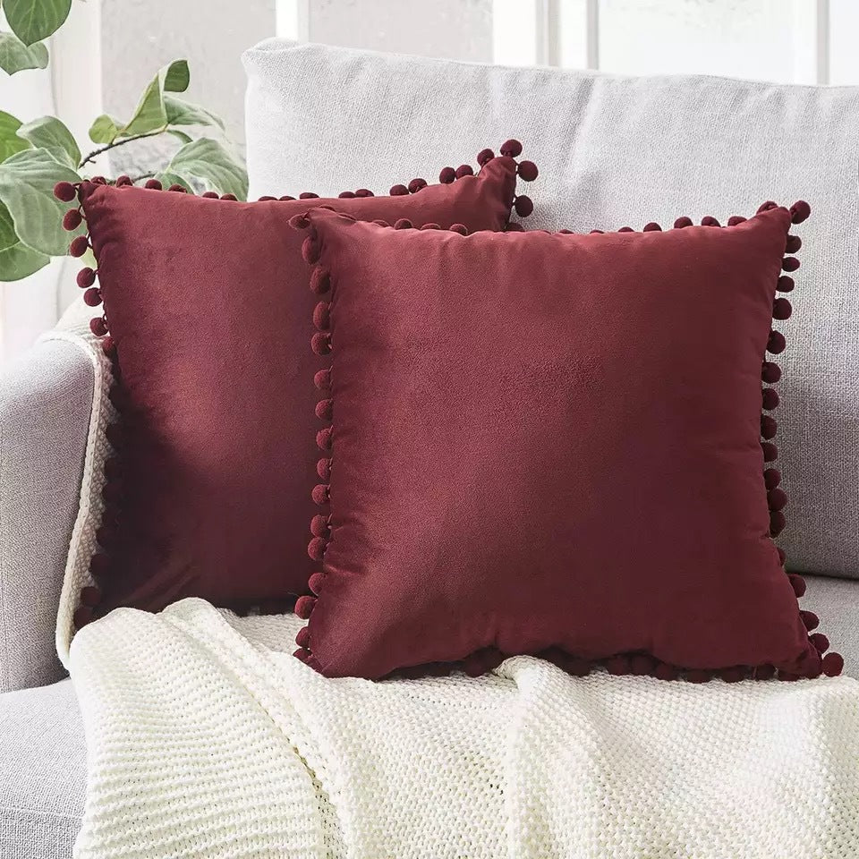 Pom Pom Velvet Pillow Cover — bronze pillows on a sofa