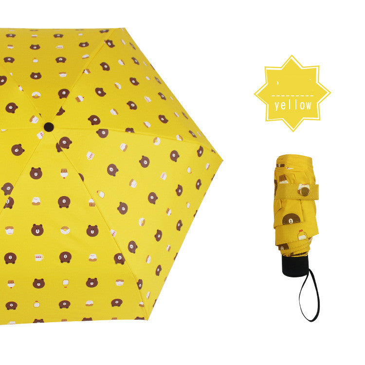 Yellow print mini umbrella shown open and folded