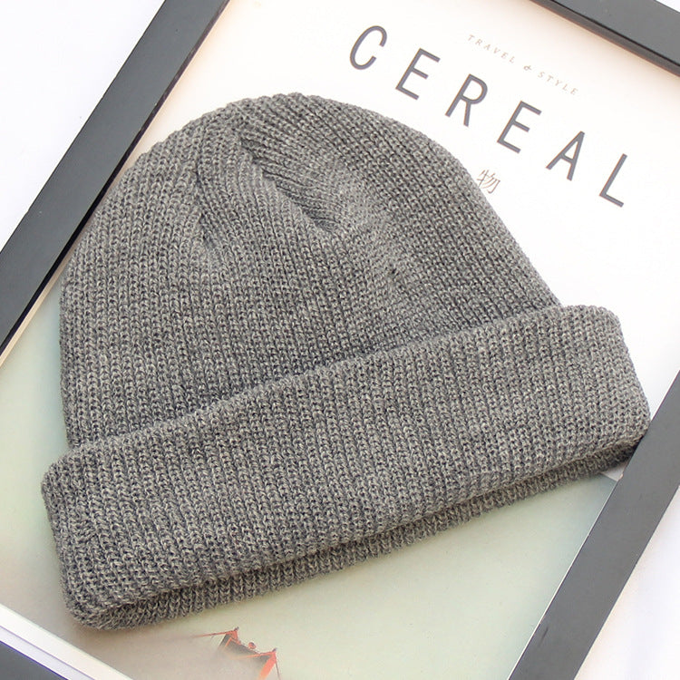 Dark grey ribbed knit beanie shown flat
