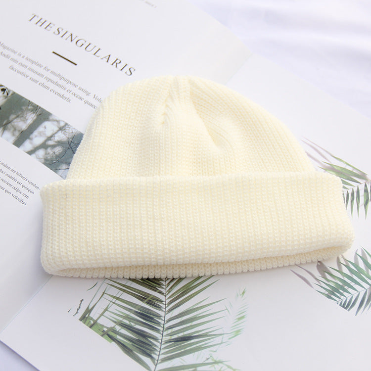 Cream white ribbed knit beanie styled with dried flowers
