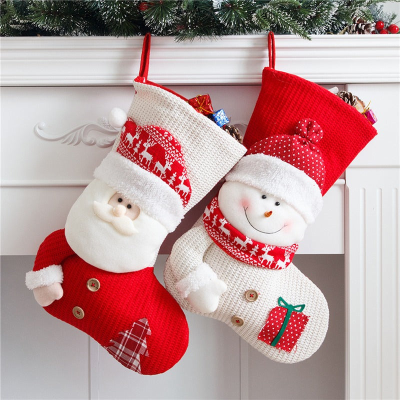 Santa and snowman knit stockings hanging from a mantel by the tree