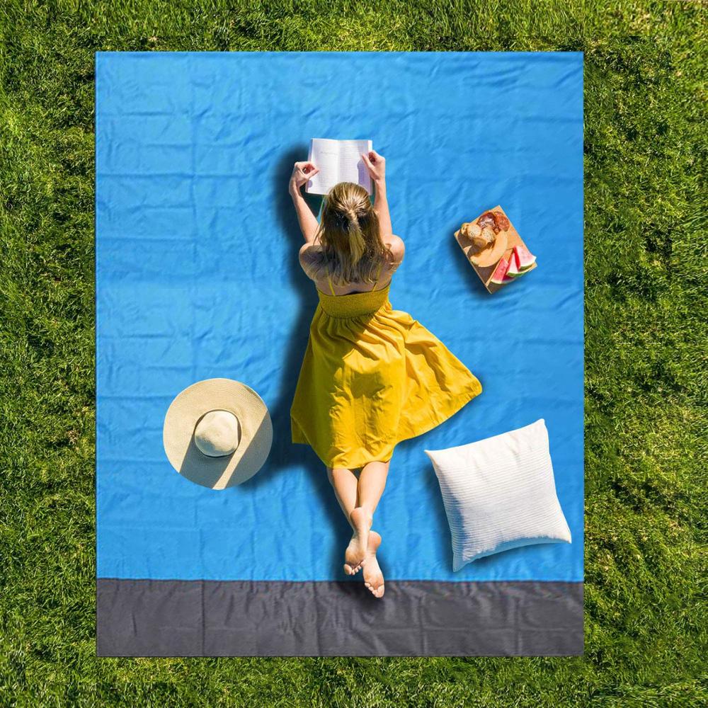 Relaxing on a blue pocket picnic blanket spread on the grass