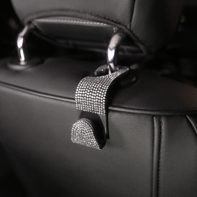Car Headrest Hook — black rhinestone hook installed on a headrest