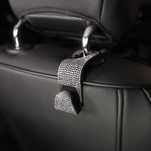 Car Headrest Hook — black rhinestone hook installed on a headrest