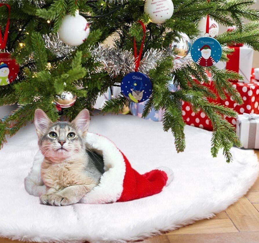 Plush Christmas Tree Skirt — cat resting on skirt under tree