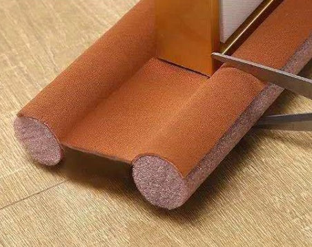 Door Draft Stopper — brown stopper under wood door