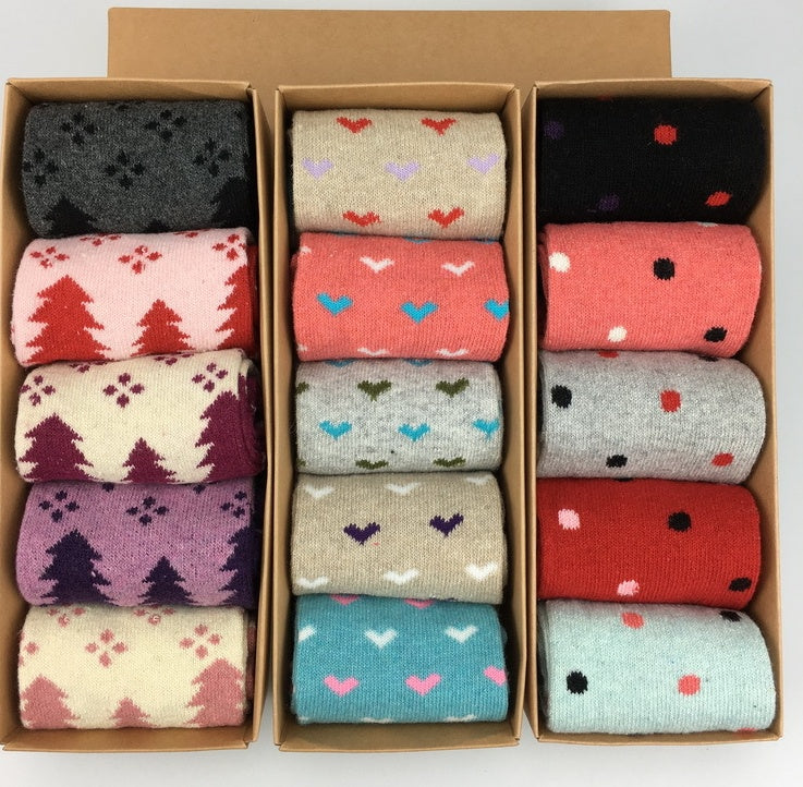 Three sock gift boxes with tree, heart, and dot knit patterns side by side