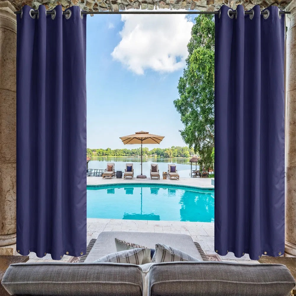 Navy outdoor curtain panels framing a poolside patio