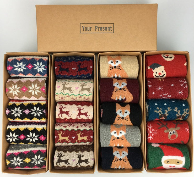 Four kraft gift boxes of cozy jacquard knit socks in assorted winter patterns