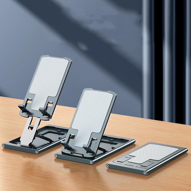Two folding aluminum phone stands holding phones on a wooden desk
