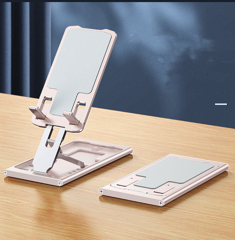 Rose gold folding aluminum phone stand on a desk