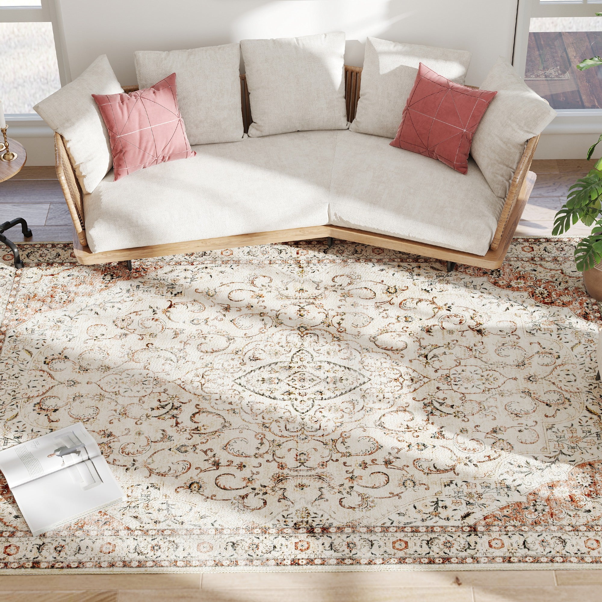 Faded floral medallion pattern of the 8x10 washable rug beside a sectional