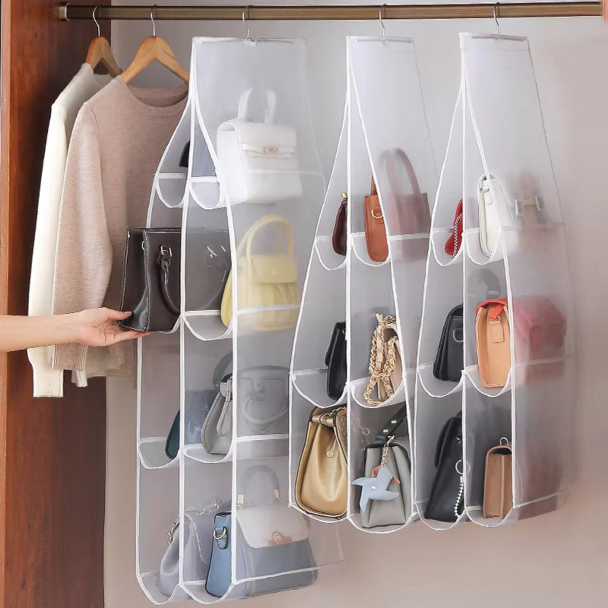 Hanging Closet Organizer — placing a handbag into one of the six clear pockets