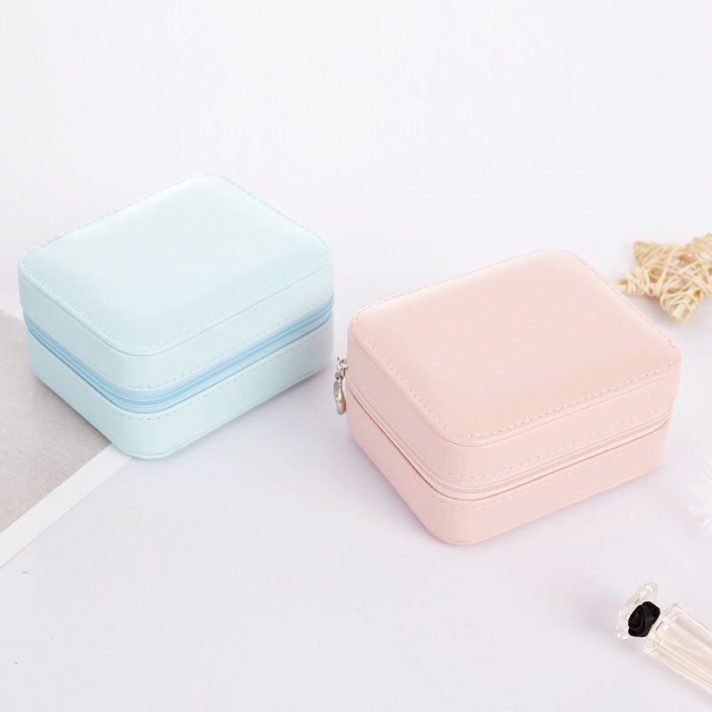 Blue and pink travel jewelry cases stacked together