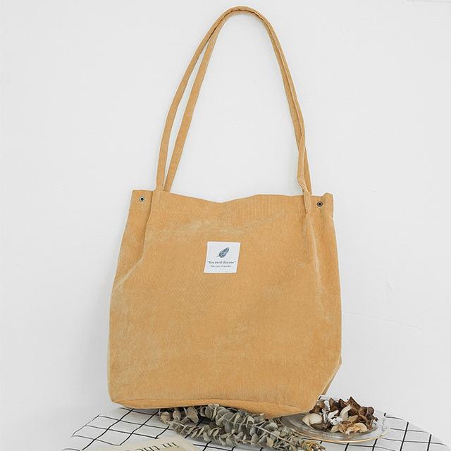 Mustard yellow corduroy tote standing upright