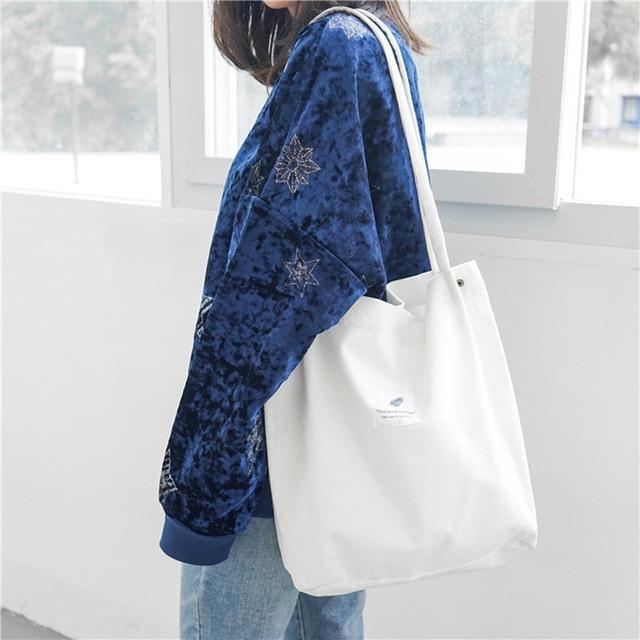 White canvas tote bag styled with a denim jacket