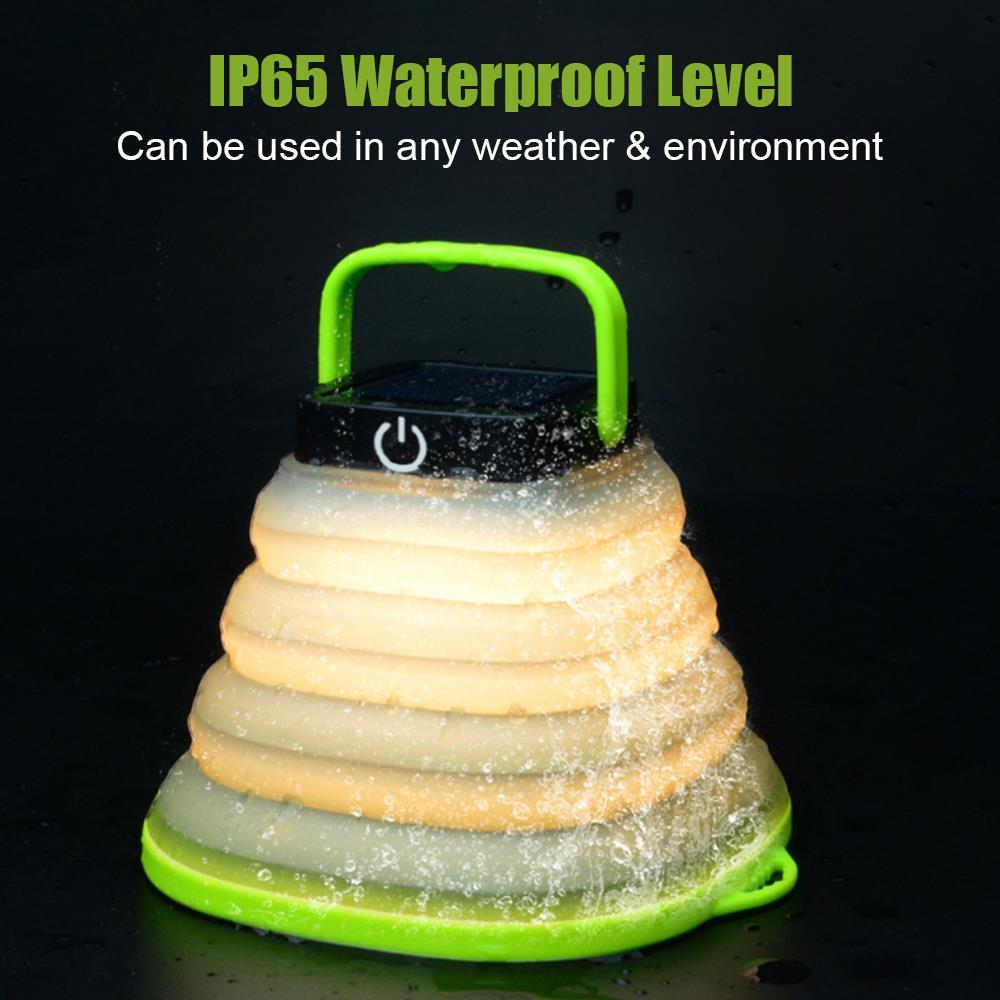 Waterproof collapsible lantern glowing while popped open outdoors