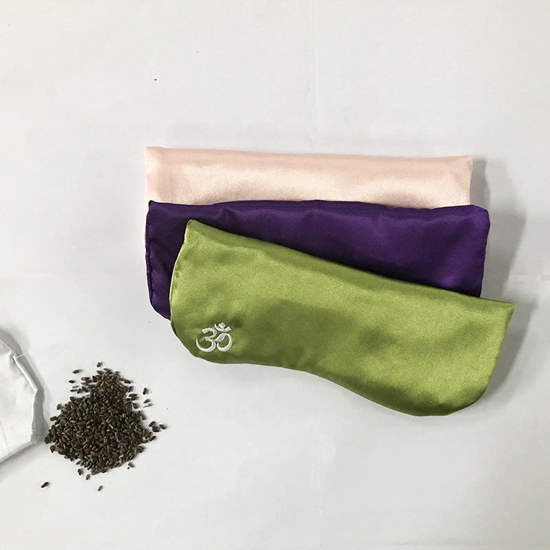 Weighted Silk Eye Pillow — pillows with dried herbal filling on a table