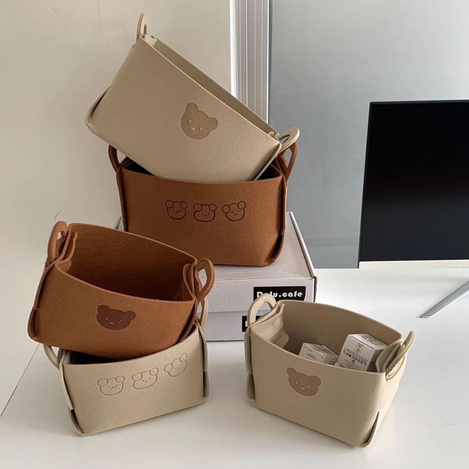 Felt Desk Organizer — two-tone felt baskets on a desk beside a monitor