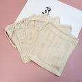 Reusable Produce Bags — folded stack of beige mesh bags