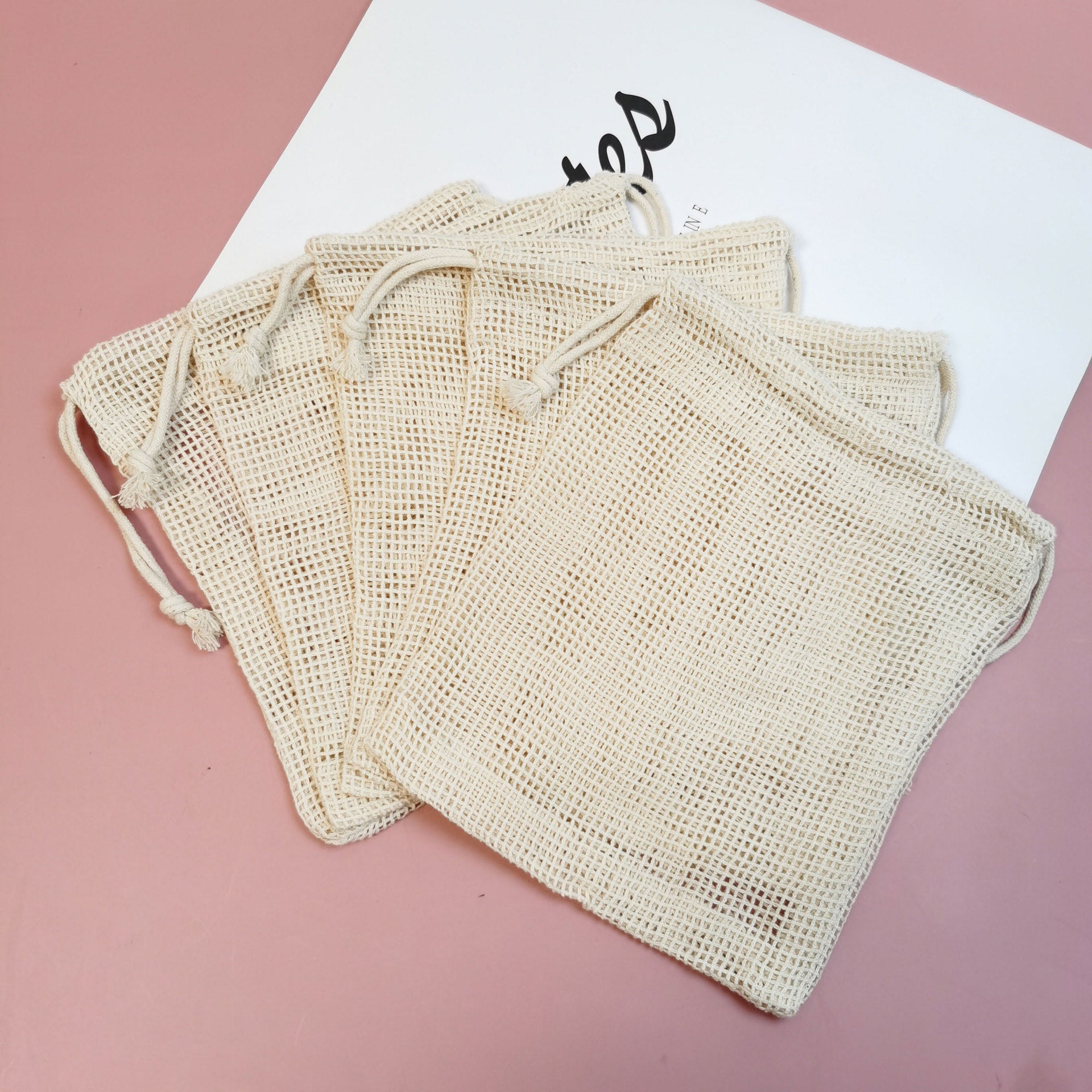 Reusable Produce Bags — folded stack of beige mesh bags