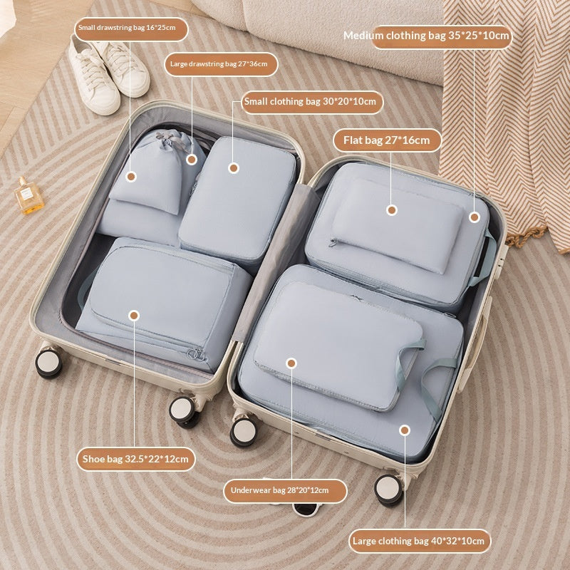 Blue eight piece packing cube set organizing a rolling suitcase