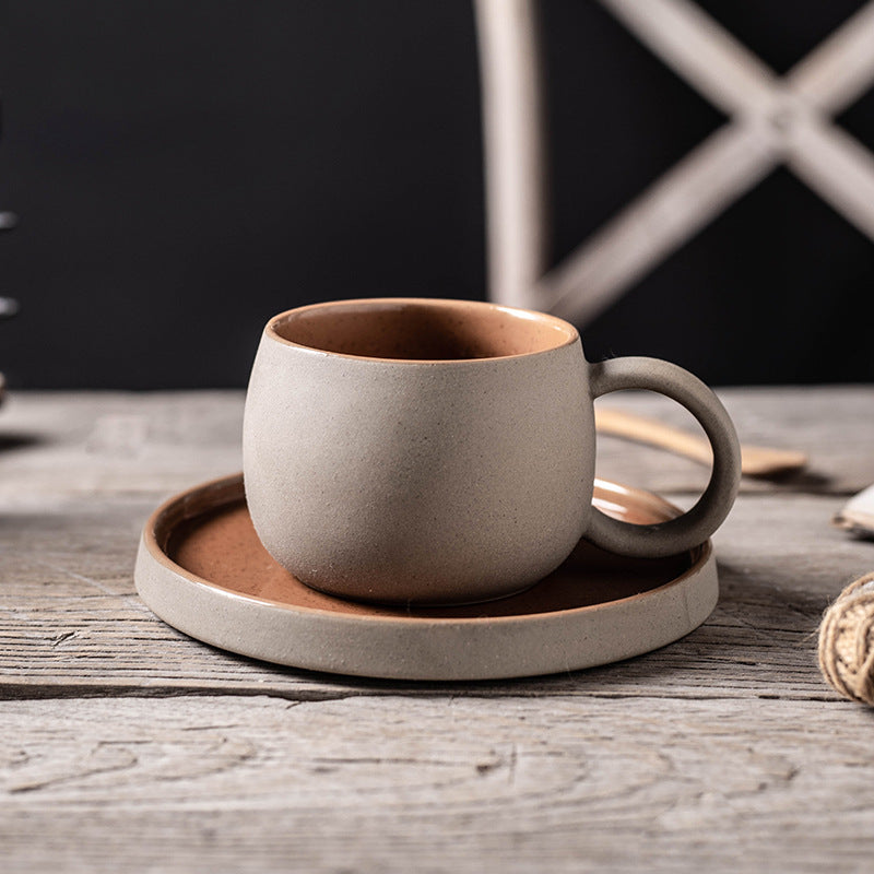 Stoneware Mug and Saucer Set — brown sand mug with saucer on a wood table