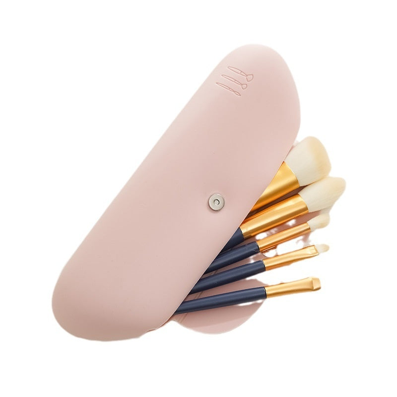 Travel Makeup Bag — bag standing open with makeup brushes inside