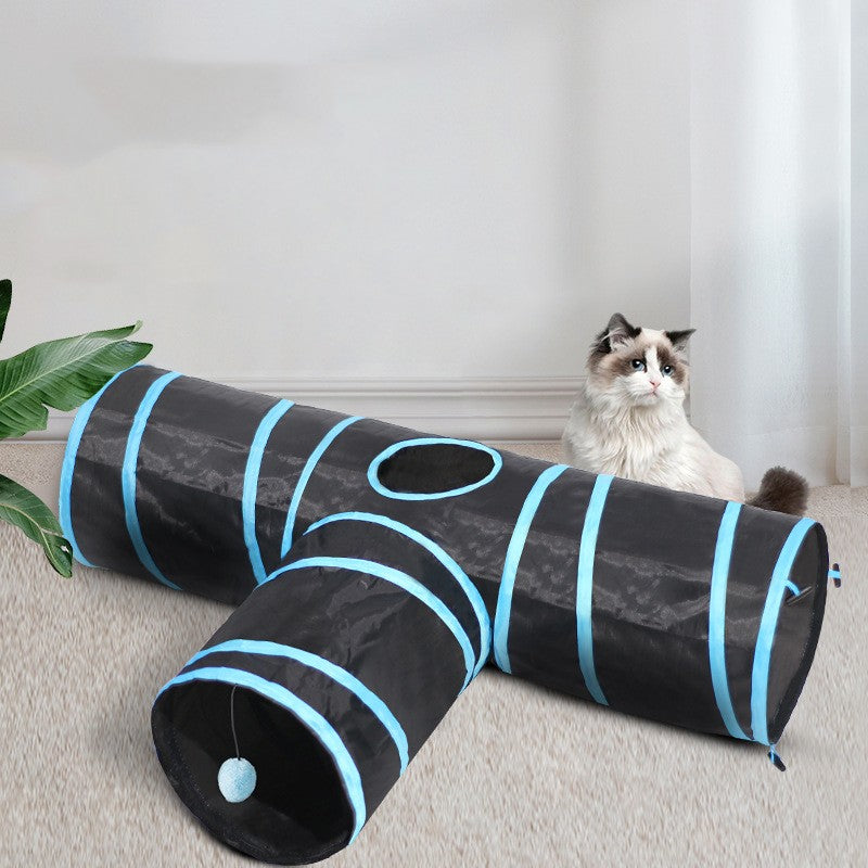 Cat perched on the black foldable play tunnel