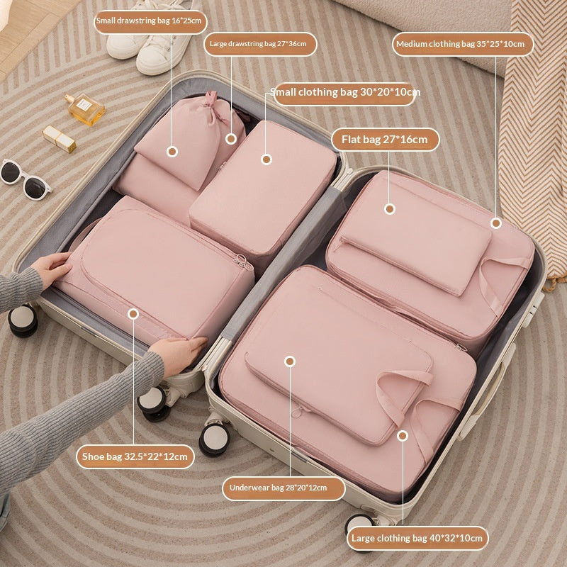 Pink eight piece packing cube set arranged in an open suitcase