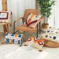 Tufted boho pillow covers styled on a rattan chair in a sunlit room