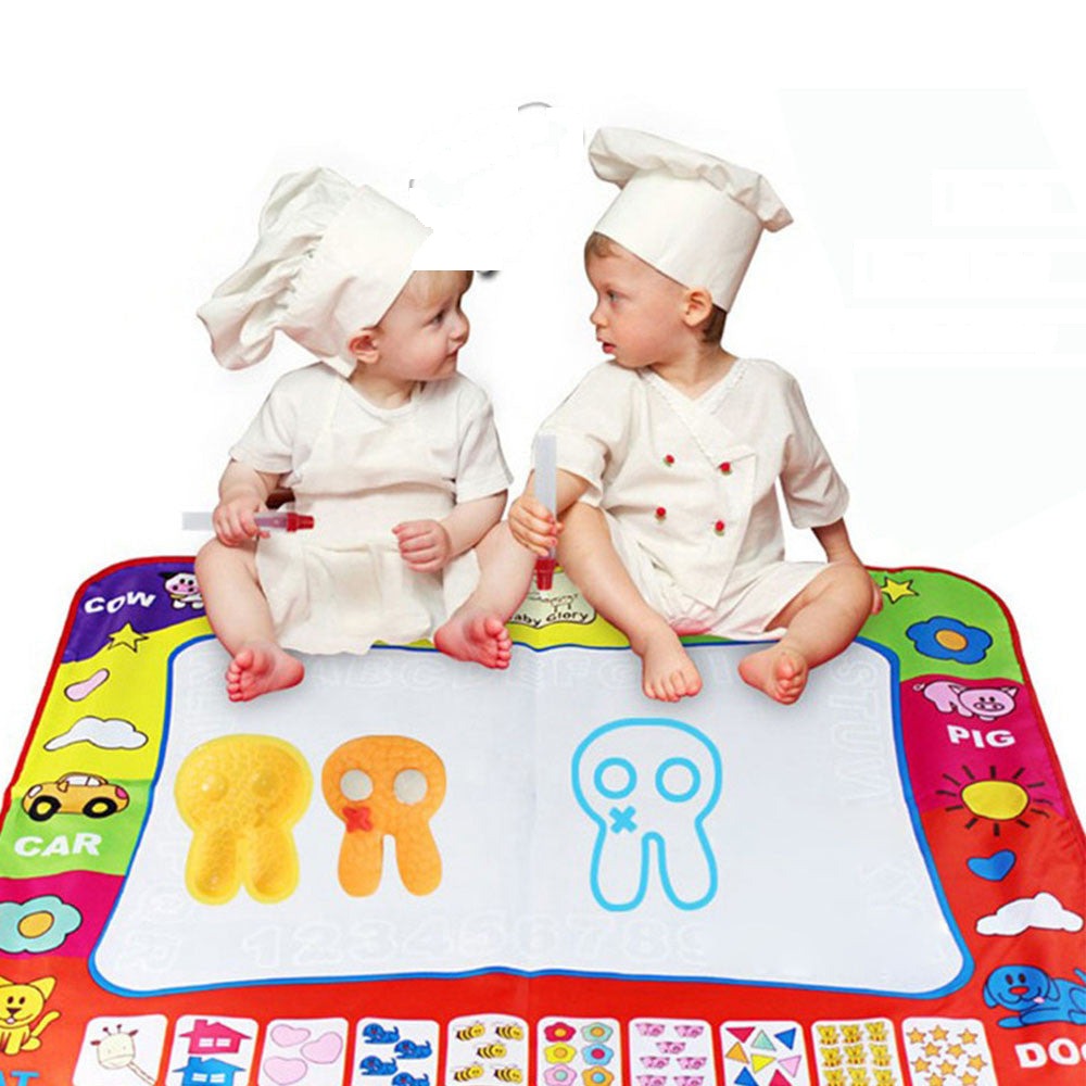 Two toddlers drawing on the water doodle mat