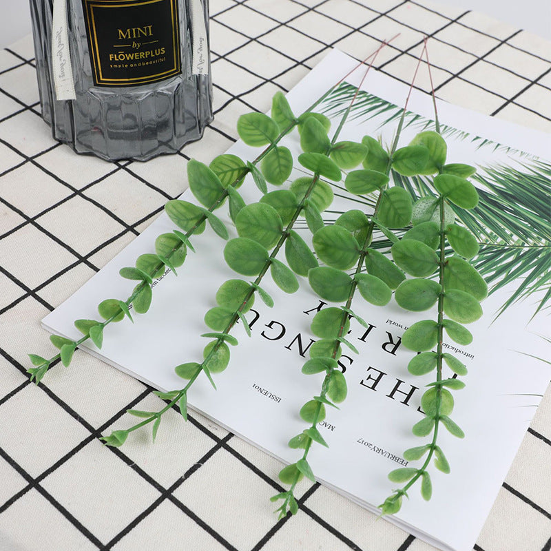 Artificial Eucalyptus Stems — light green stems hung on a grid wall