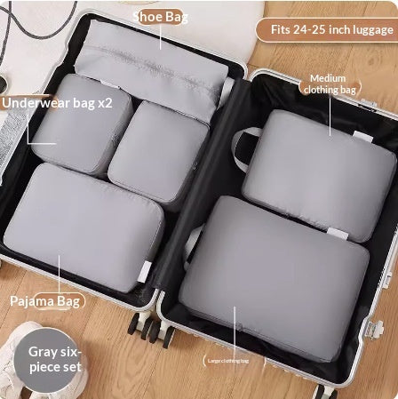 Gray six piece packing cube set fitted neatly into a suitcase