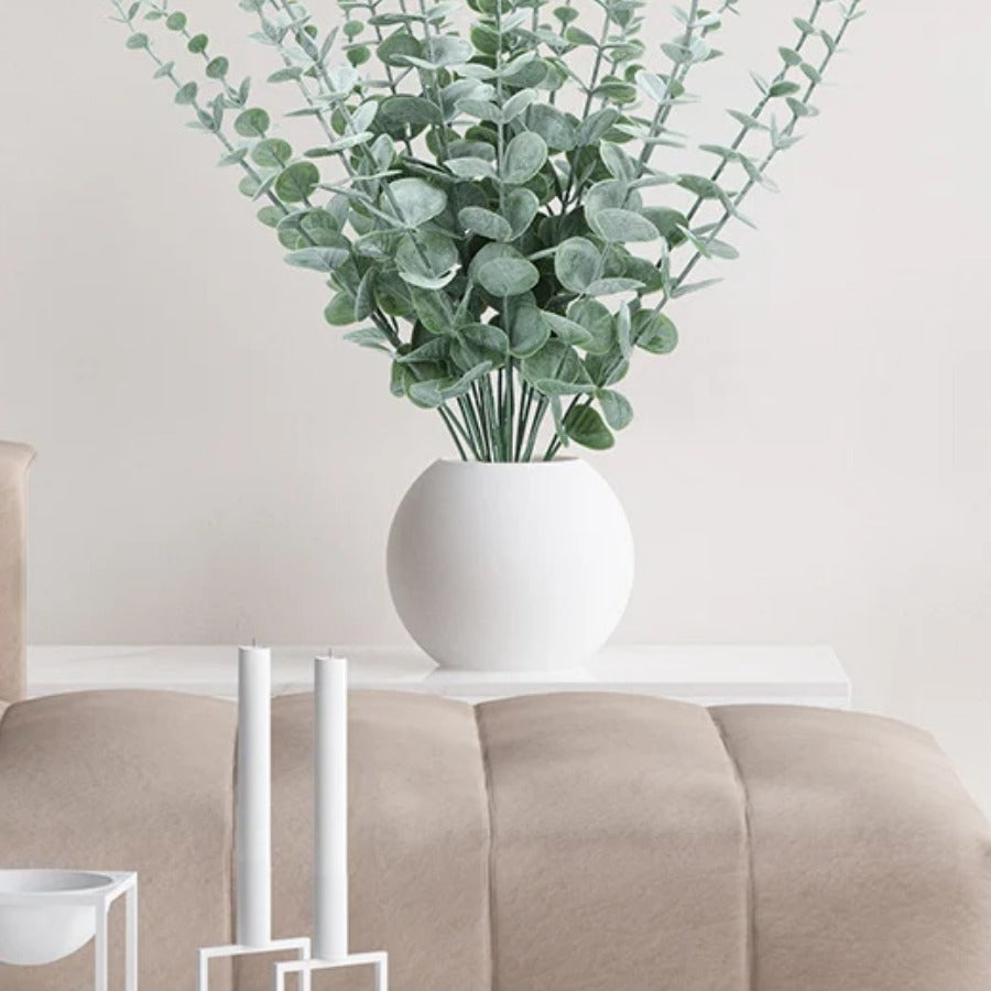 Artificial Eucalyptus Stems — arranged in a white vase