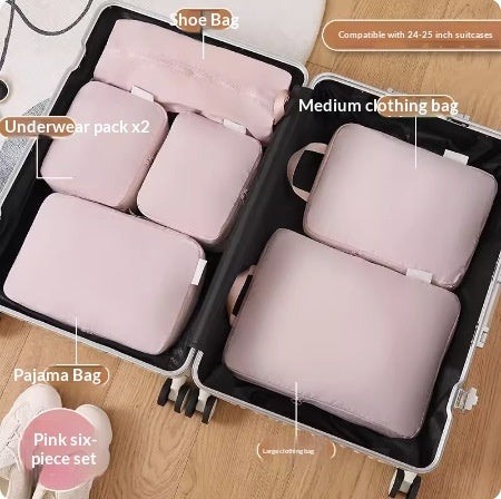Powder pink six piece packing cube set inside a suitcase