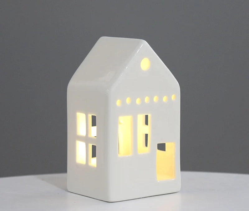 Tall white ceramic townhouse tea light holder with glowing windows